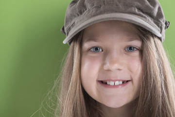 smiling girl in green cap