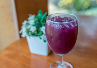 Glass of grape juice with ice