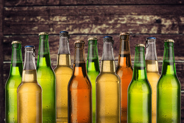 Group of cold wet beer bottles on the grunge background