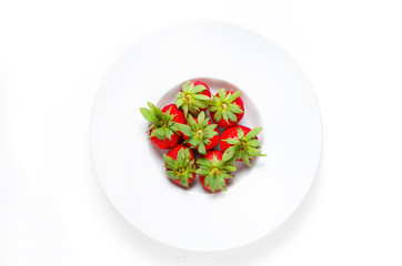 Fresh strawberries in a bowl on a white background from above