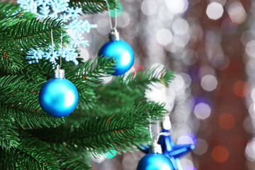 Christmas tree with decor on bright background, closeup