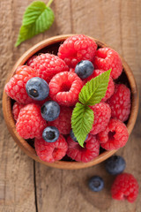 fresh berries raspberry blueberry in wooden bowl
