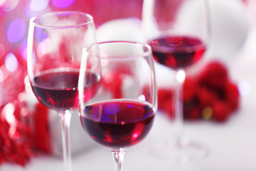Wineglasses on red blurred lights background