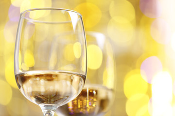 Wineglasses on blurred lights background