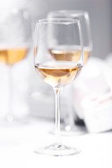 Wineglasses on light blurred background