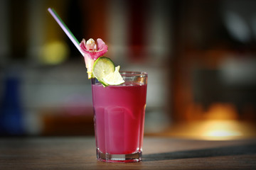 Glass of cocktail on bar background