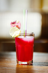 Glass of cocktail on bar background