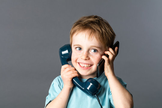cheeky boy talking on both ears for two voices communication