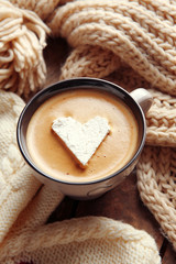 Cup of coffee with marshmallow on wooden table