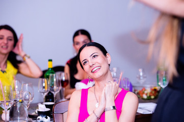 Cheerful bride and bridesmaids celebrating hen party with drinks