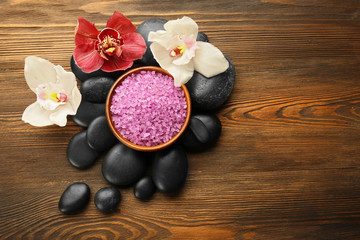Obraz na płótnie Canvas Beautiful spa composition with stones and orchids on wooden background