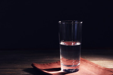 Glass of pure water on wooden table