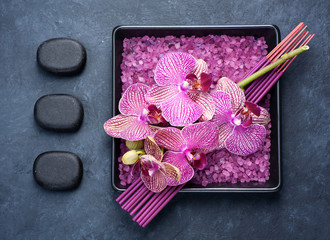 Spa aromatherapy background. massage stones, incense sticks and orchid flowers