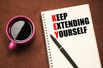 KEY Acronym - text on notebook with a pen and cup of coffee
