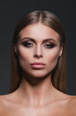 Obraz premium Beauty close-up studio portrait of a beautiful and self-confident blond girl looking straight. Vertical. Shoulders