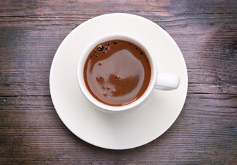Cup of fresh coffee on wooden background