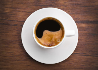 Cup of fresh coffee on wooden background