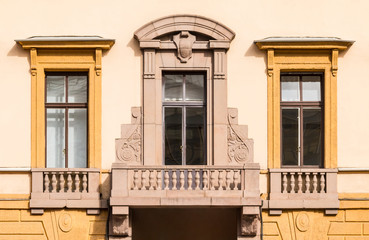 Obraz premium Three windows in a row and balcony on facade of urban office building front view, St. Petersburg, Russia.