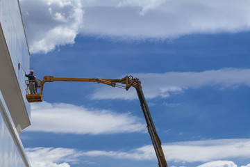 cleaning skyscrapers outside with a crane - window washing
