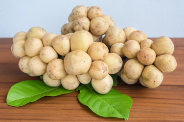 Longkong (Lansium parasiticum), tropical fruit on wooden table