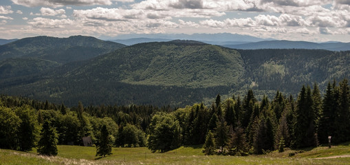 mountain panorama with Tatras mountain range on the background from Hala Rycerzowa in Beskid Zywiecki mountains in Poland