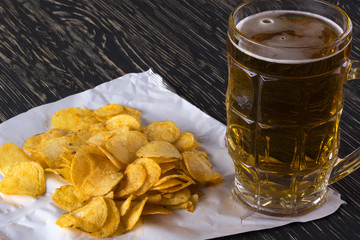 Potato chips and glass of beer.
