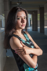 Fashion style photo of a young woman at urban background