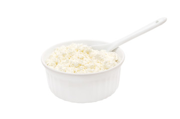 White bowl of cottage cheese with spoon isolated on white