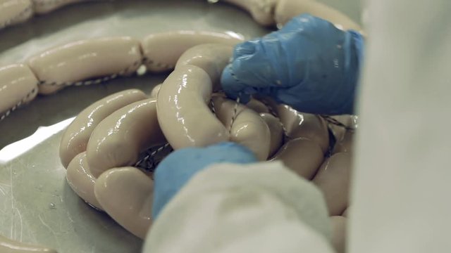 Industrial production of sausages. Production and packing of salami and bologna sausage in the meat industry. 