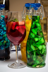 summer fruit painted cocktails, lemonade, wine in glass, studio photo