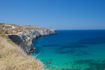 Fototapeta premium Maltese landscape, scenic view in Bahrija area, Malta. Maltese coastline with the cliffs,gold rocks over the sea in Malta with the blue clear sky background,Malta, Bahrija.