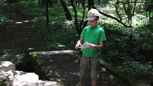 Geocaching - on the Ruins of an Old House With Graffiti Boy Looking For a Hiding Place