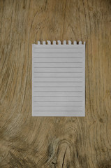 notebook paper on wood background