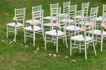 Bags of rose petals on the chiavari chair