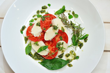 the Italian restaurant menu dish Caprese on the white plate