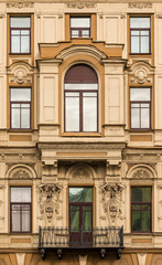 Several windows in a row and bay window on facade of urban office building front view, St. Petersburg, Russia.
