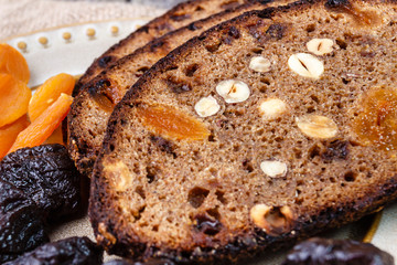 Sliced rye bread with prunes, dried apricots and hazelnut on old rustic table