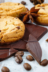 Chocolate cookies with chocolate chips, coffe beans and anise on the light wooden background