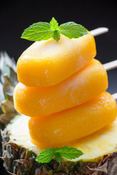 Column of pineapple sorbet ice cream popsicles.