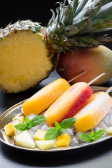 Pineapple mango strawberry sorbet ice cream popsicles.