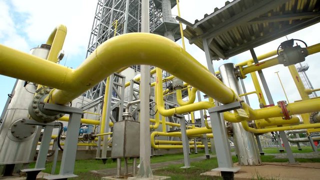 yellow pipe on gas plant. shot with slider