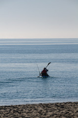 Canoeist wiht fishing rod, Mediterranean Sea, Spain
