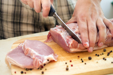 a man with a knife cut a piece of beef