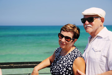 senior couple walking near the sea