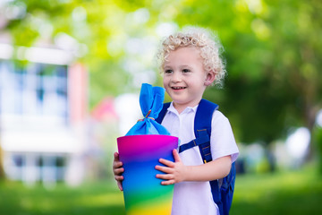 Little child with candy cone on first school day