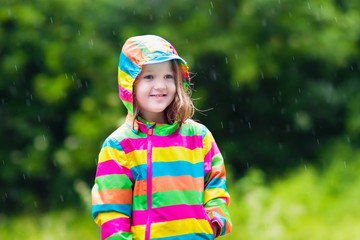 Child playing in the rain