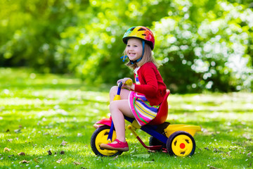 Little girl riding a tricycle