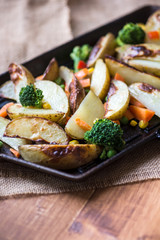 Potato Wedges with Vegetables on Iron Cast Pan