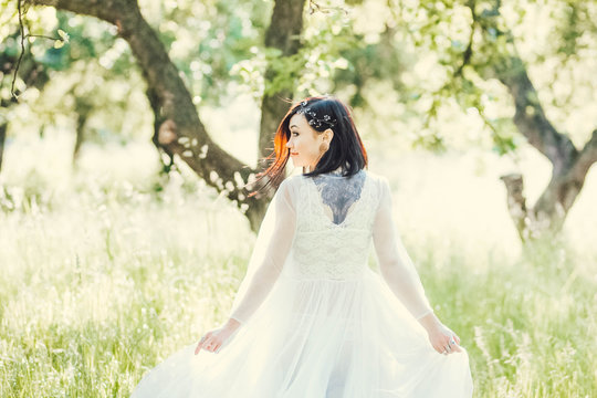 Beautiful bride dreaming, at a photo session in the nature