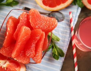 Ripe grapefruits and fresh juice with mint, close up